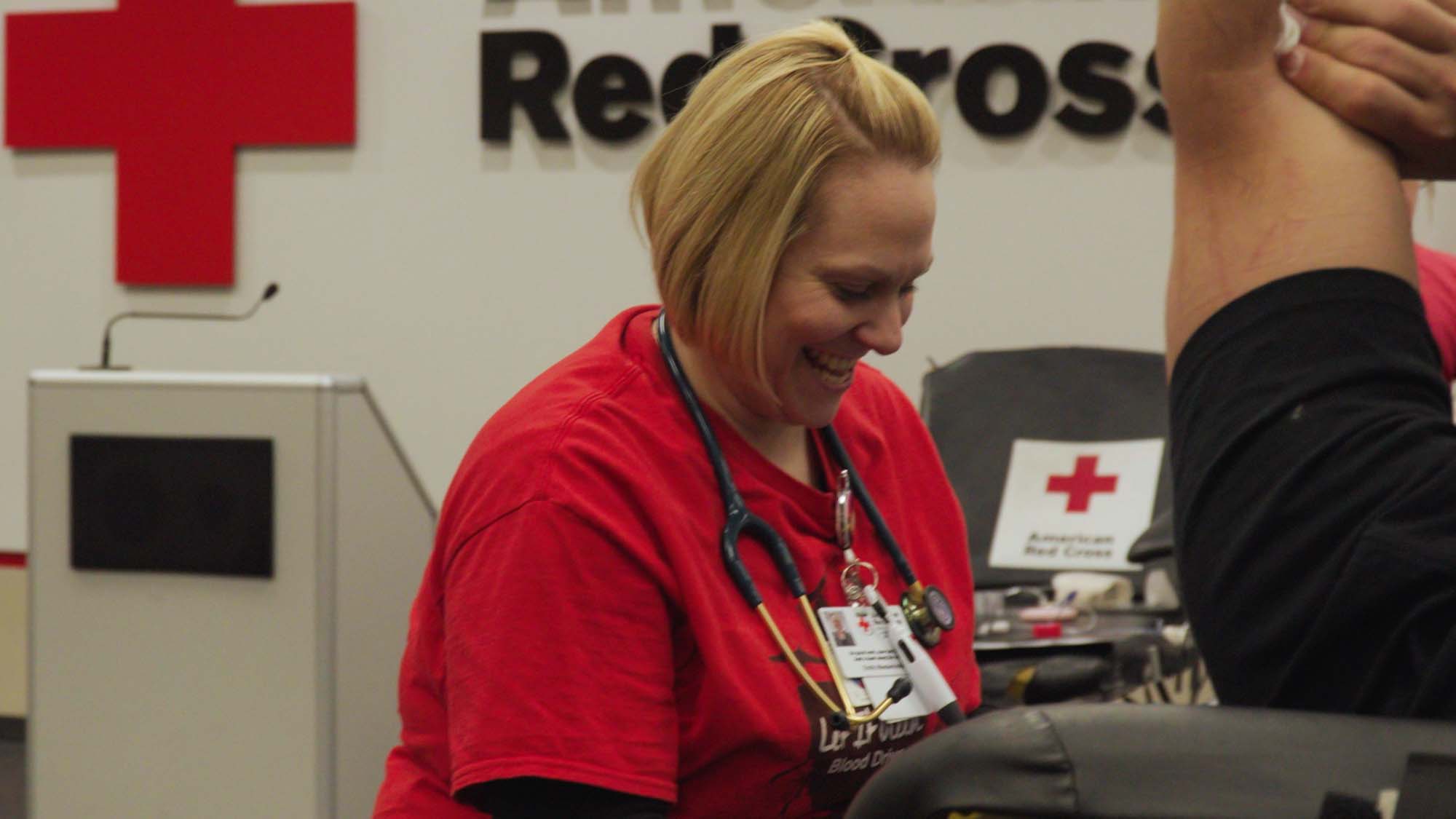 A Red Cross volunteer draws blood from a donor.